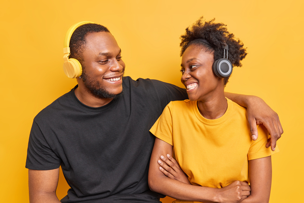 A imagem contém dois jovens abraçados e sorridentes dando apoio um ao outro, uma ação importante para a campanha Setembro Amarelo.